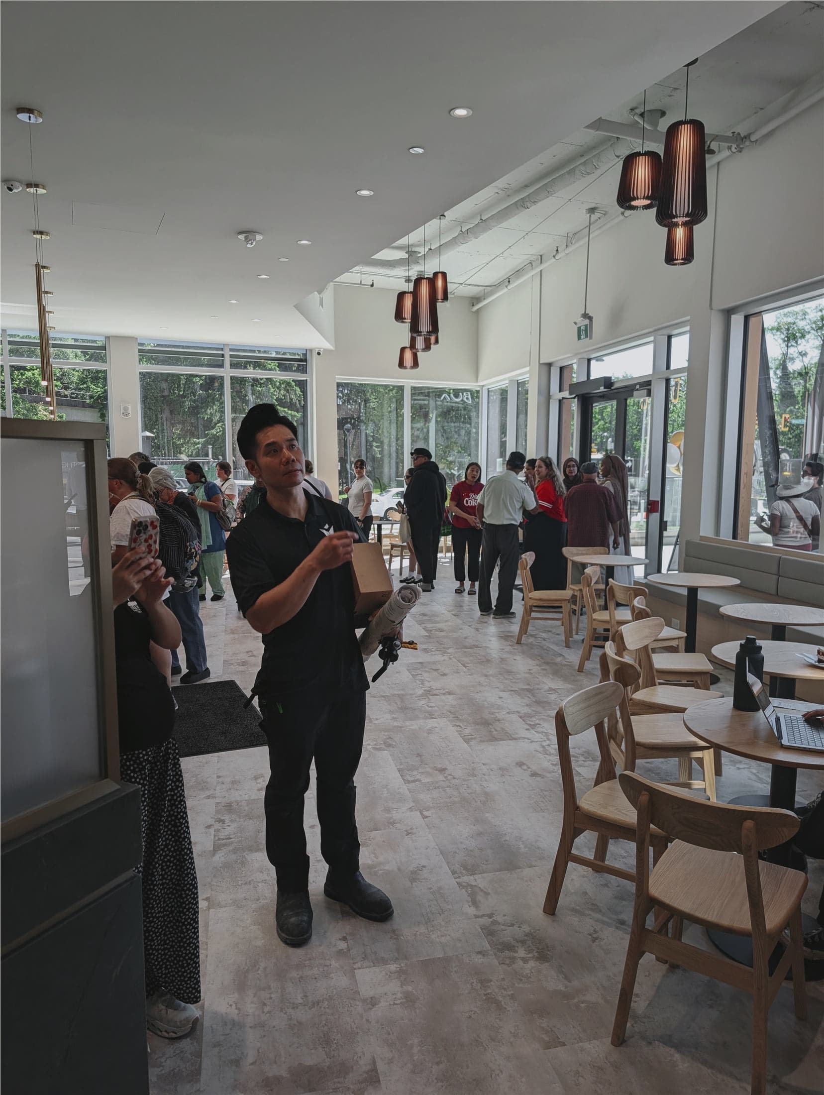 Completed cafe interior with seating, glazing, and lighting