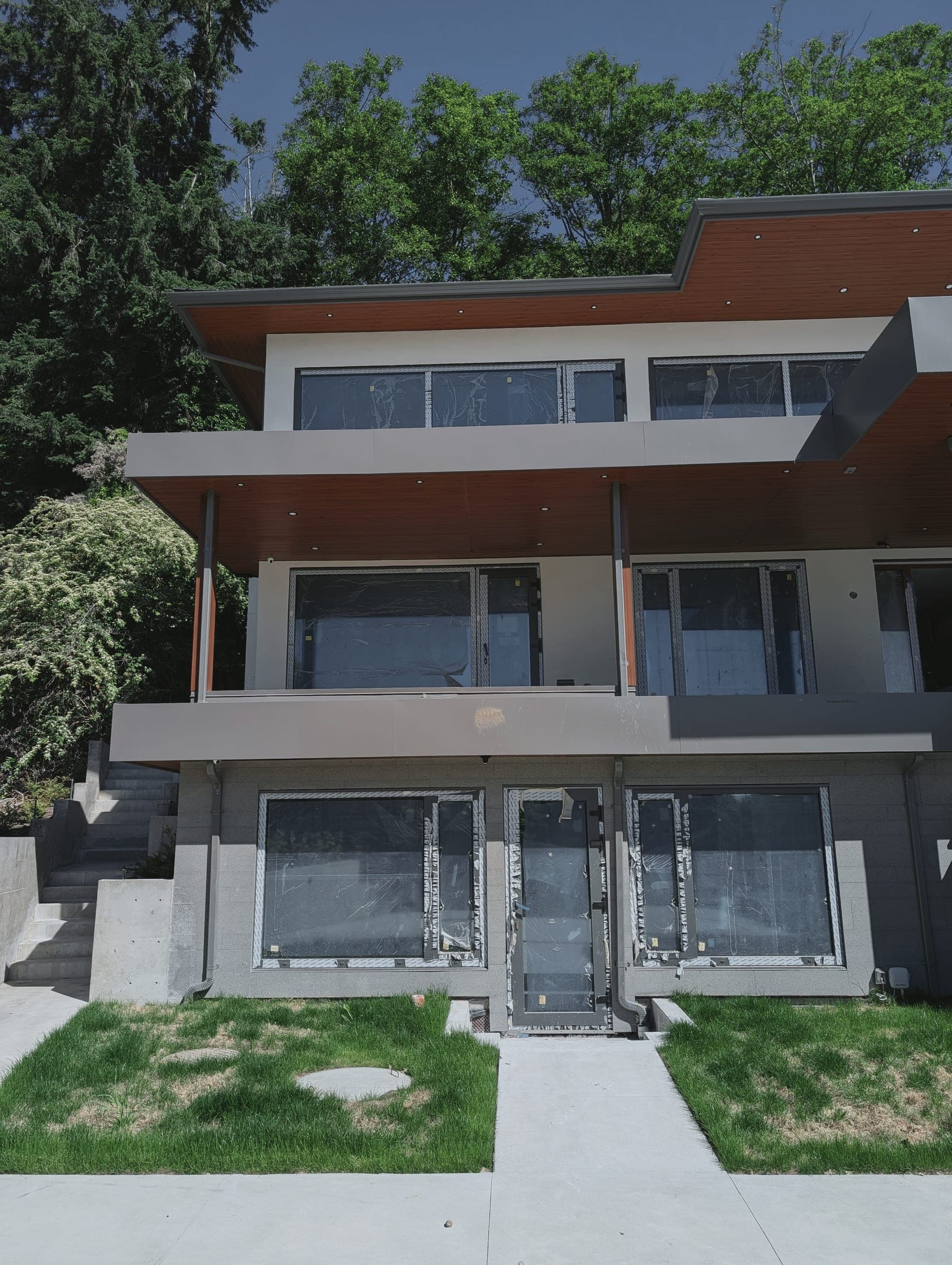 Completed residential interior with warm wood ceiling and broad glazing